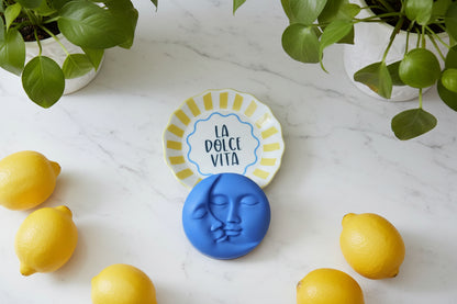 La dolce vita trinket on a marble countertop with around plants and lemons