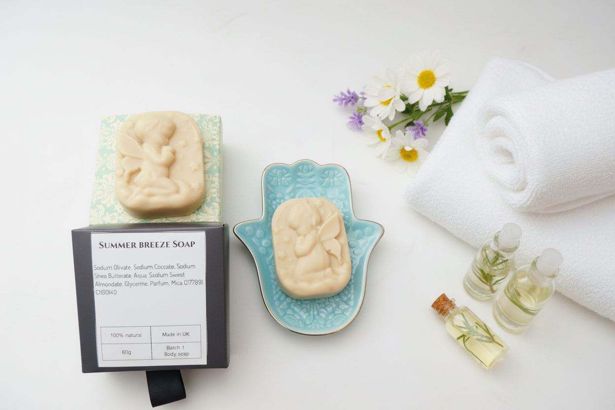 Summer Breeze Soap product shown with its black retail box, a carved pale beige soap bar resting on a light blue patterned dish, and the soap box.