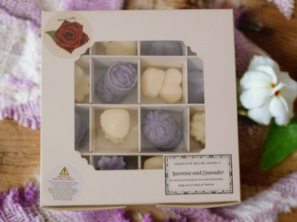 A box of handmade soya wax melts with a Jasmine and Lavender collection. The box is closed, showing multiple pieces of wax melts in shades of purple and white.
