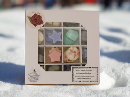 Handmade soya wax melts in various shapes and colors displayed in a gift box with a 'Winter Collection' label.